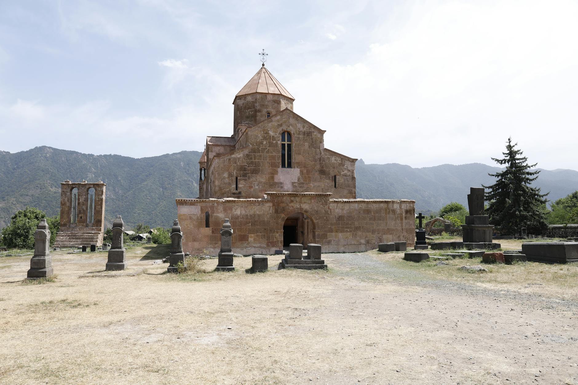 Zabytkowy klasztor na Podhalu otoczony cmentarzem na tle gór